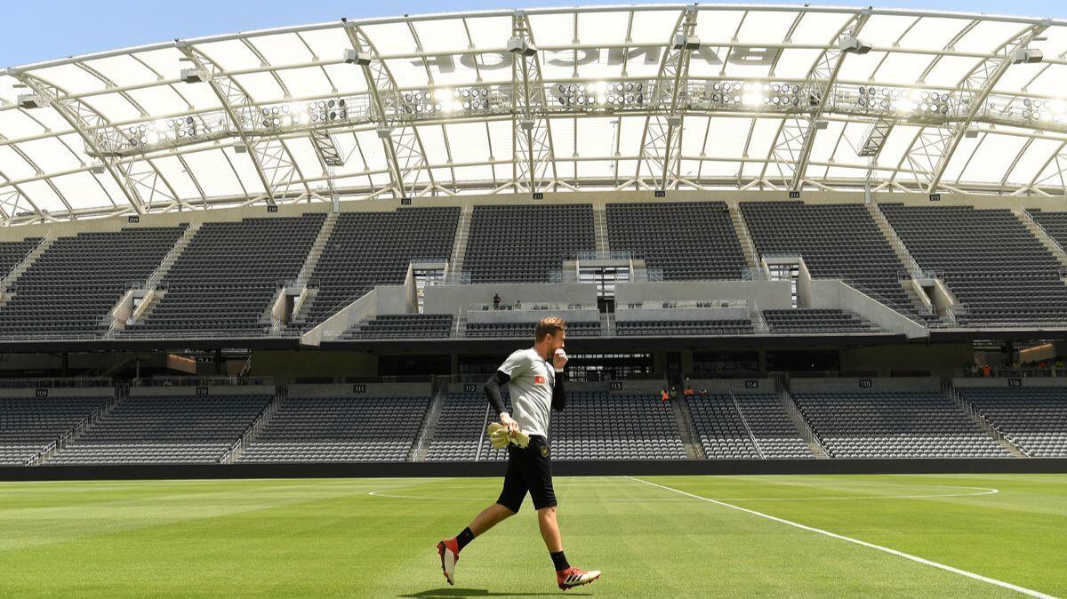 A LAFC player runs on the field at Banc of California Stadium.