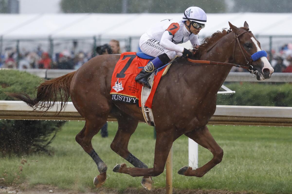 Mike Smith rides Justify through the fourth turn and on to victory during the 144th running of the Kentucky Derby.