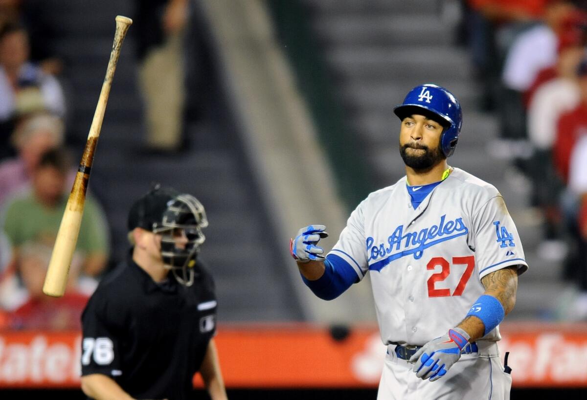 Dodgers center fielder Matt Kemp tosses his bat after striking out against the Angels in May. How will Kemp's absence affect the Dodgers' postseason?
