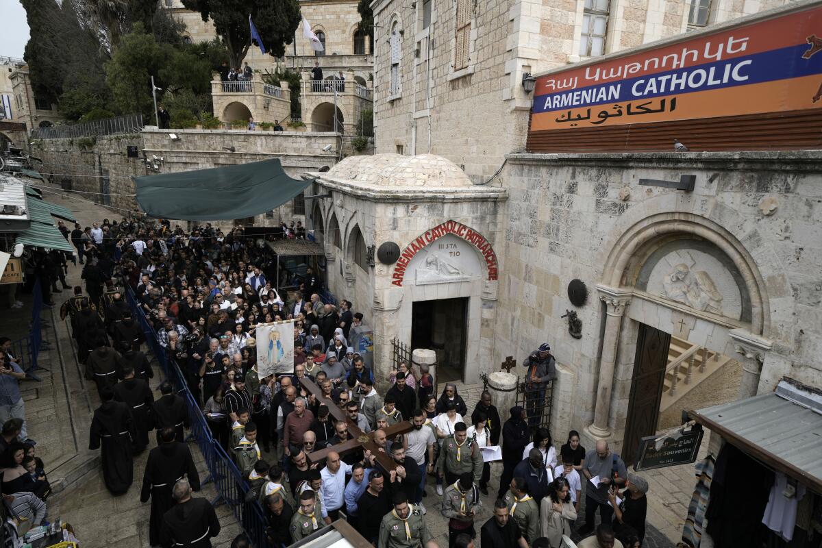Christians walk the Way of the Cross procession in the Old City of Jerusalem.