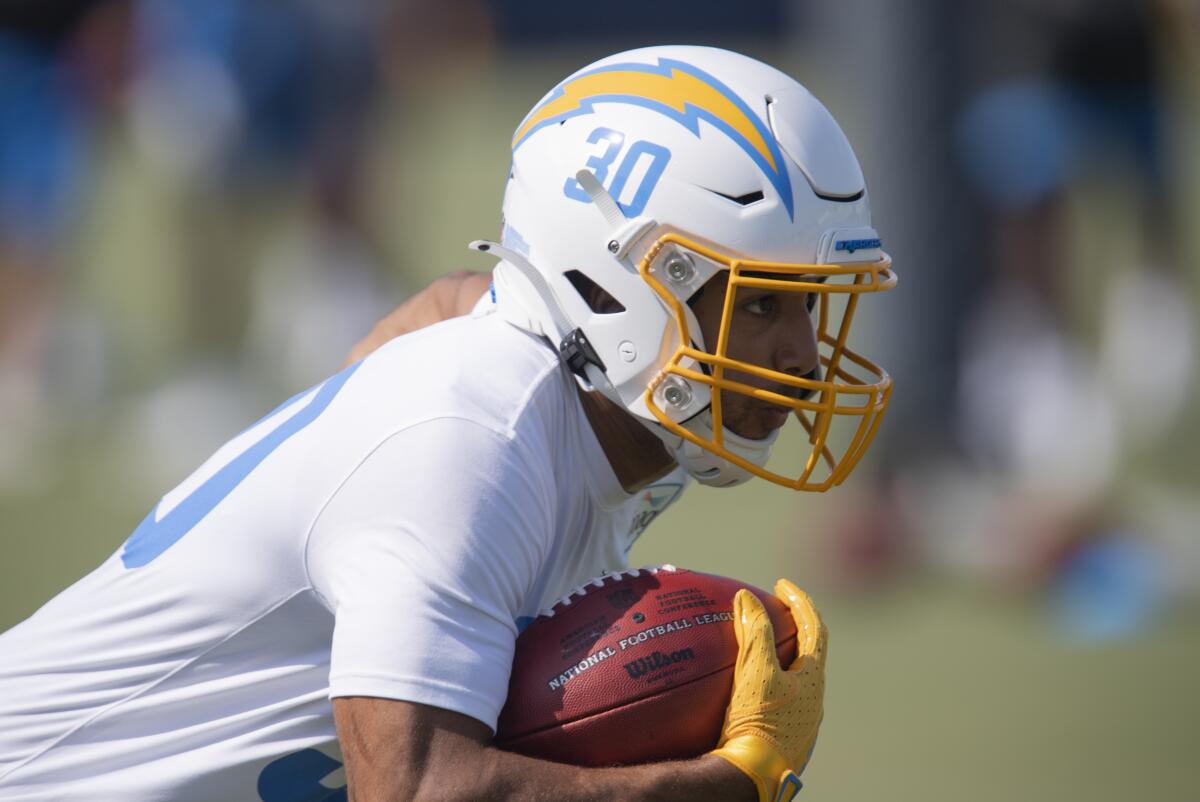 Chargers running back Austin Ekeler runs a drill with football in hand.