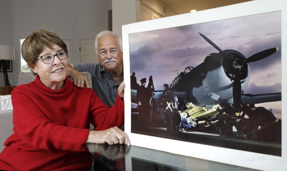 Katherine Wall Panatone, left, and her husband Steve Peck with one of her father Herman V. Wall's award-winning photographs.