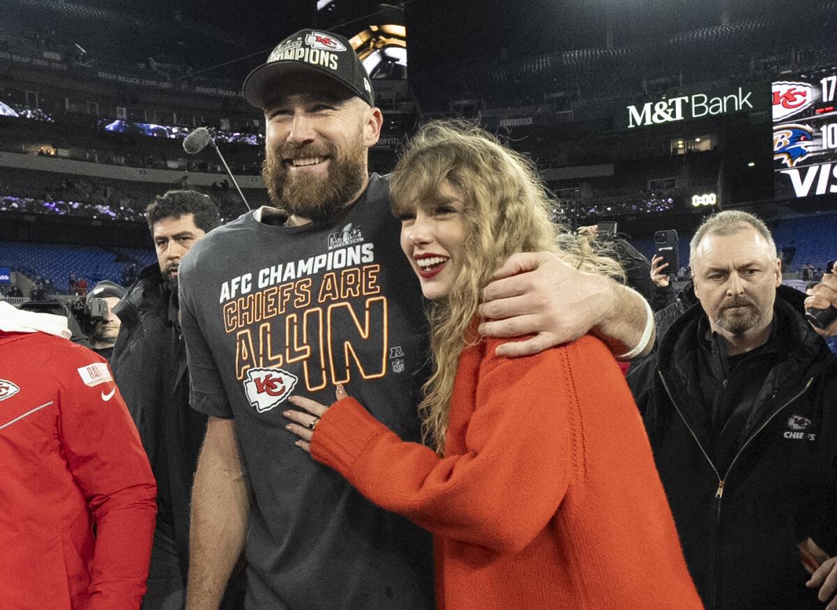 Travis Kelce walks with an arm around Taylor Swift's shoulder following the AFC Championship