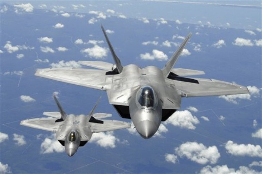 In this April 2, 2007 file image provided by the US Air Force, two U.S. Air Force F-22 Raptor aircraft flying in trail behind a KC-135R Stratotanker aircraft after inflight refueling during a training mission off the coast of Florida, are shown. Defense Secretary Robert Gates said Monday, April 6, 2009, the Pentagon will end the F-22 fighter jet and presidential helicopter programs run by Lockheed Martin Corp. (AP Photo/US Air Force, Thomas Meneguin, file)