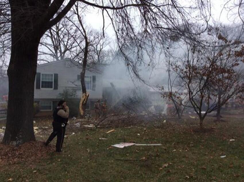 Smoke is seen after a small plane crashed in to a home and damaged others in Gaithersburg, Maryland.