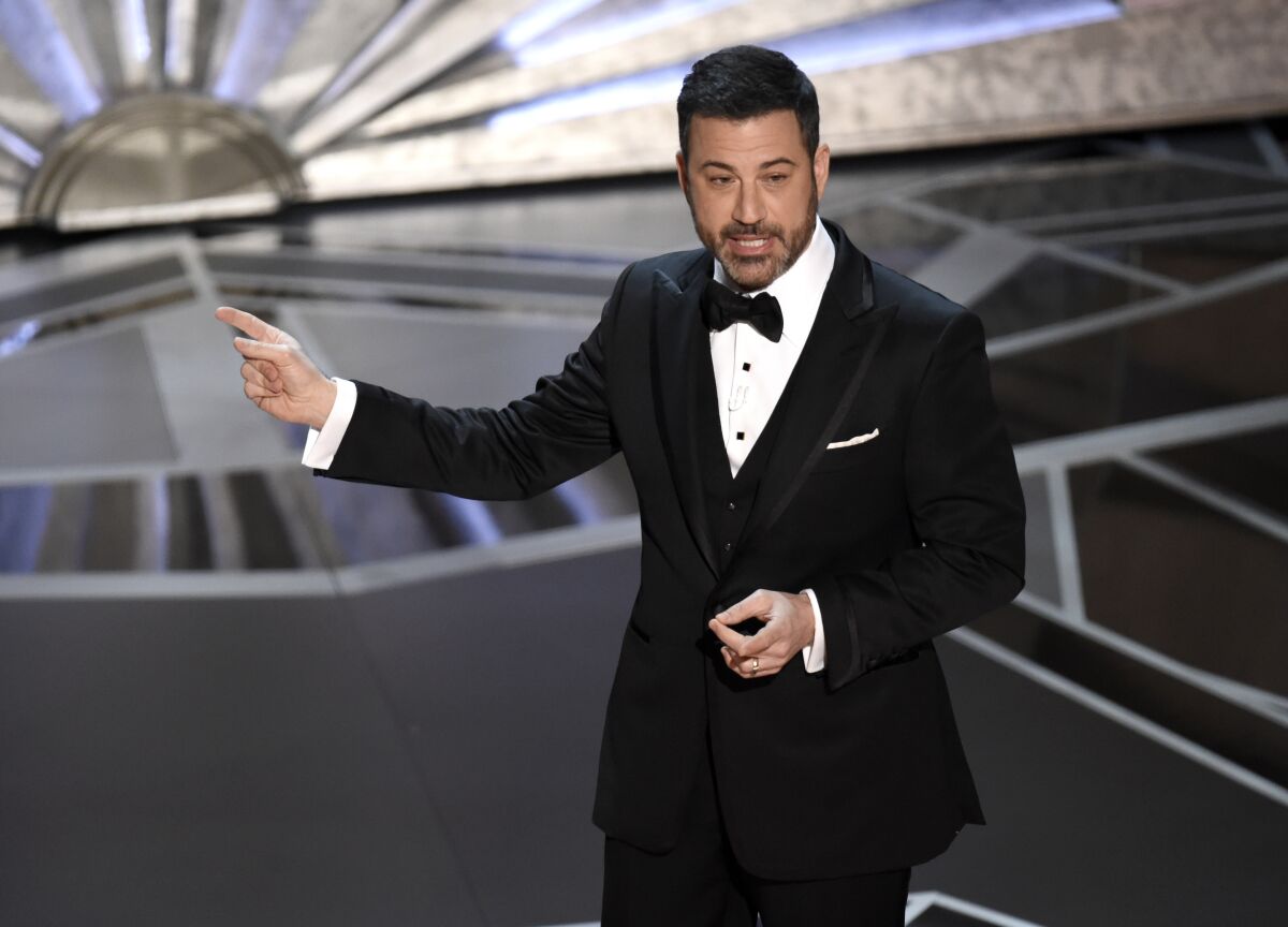 FILE - Host Jimmy Kimmel speaks at the Oscars in Los Angeles on March 4, 2018. Kimmel will again preside over the ceremony in March, the show’s producers said Monday. (Photo by Chris Pizzello/Invision/AP, File)