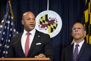 Maryland Gov. Wes Moore, left, flanked by Attorney General Anthony Brown, speaks during a news conference announcing a lawsuit seeking damages from the owners and managers of the Dali cargo ship that crashed into the Francis Key Scott Bridge, Tuesday, Sept. 24, 2024, in Baltimore. (AP Photo/Stephanie Scarbrough)