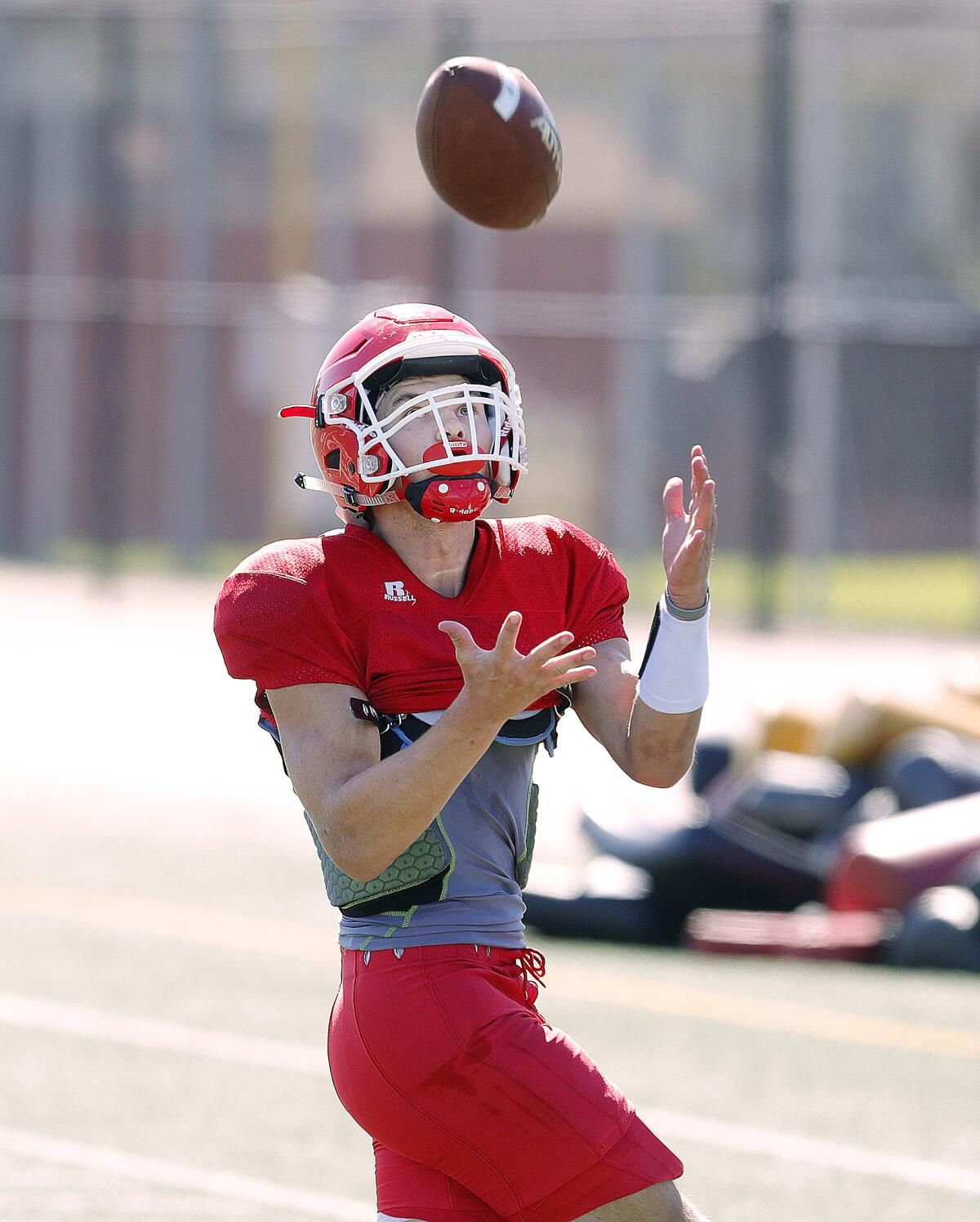 Burroughs' Aiden Forrester waits for the ball to float into his arms during a passing drill at football practice at Burroughs High School in Burbank on Tuesday, August 13, 2019.