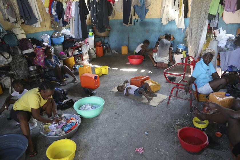 Families displaced by gang violence do laundry inside a school where they have been taking refuge for over a year in Port-au-Prince, Haiti, Friday, Sept. 20, 2024. (AP Photo/Odelyn Joseph)