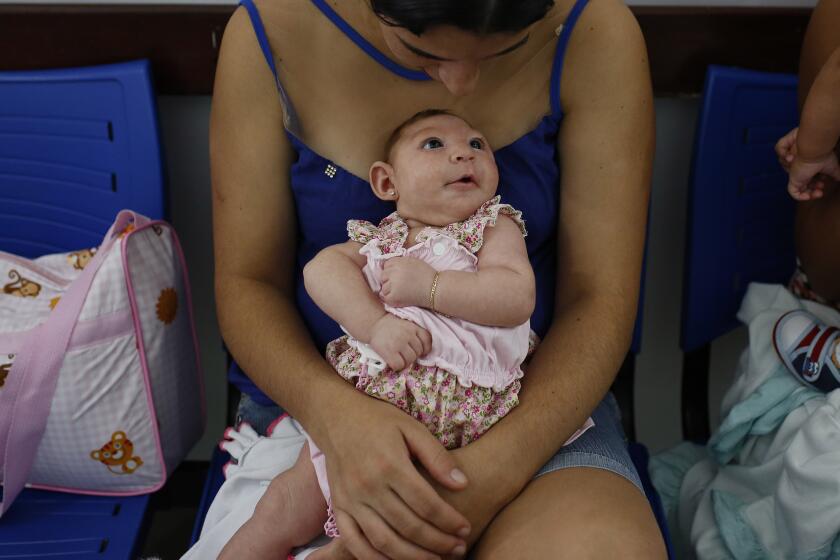 Maria Silva Flor, 20, holds her 2-month-old baby, Maria Alves, who was born with microcephaly.