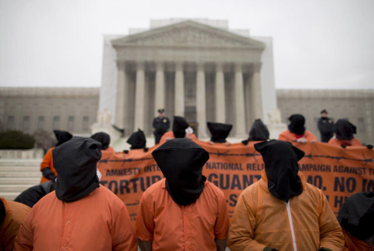 Demonstrators, dressed as detainees, protest against the U.S. military detention facility in Guantanamo Bay, Cuba, in front of the Supreme Court in Washington.