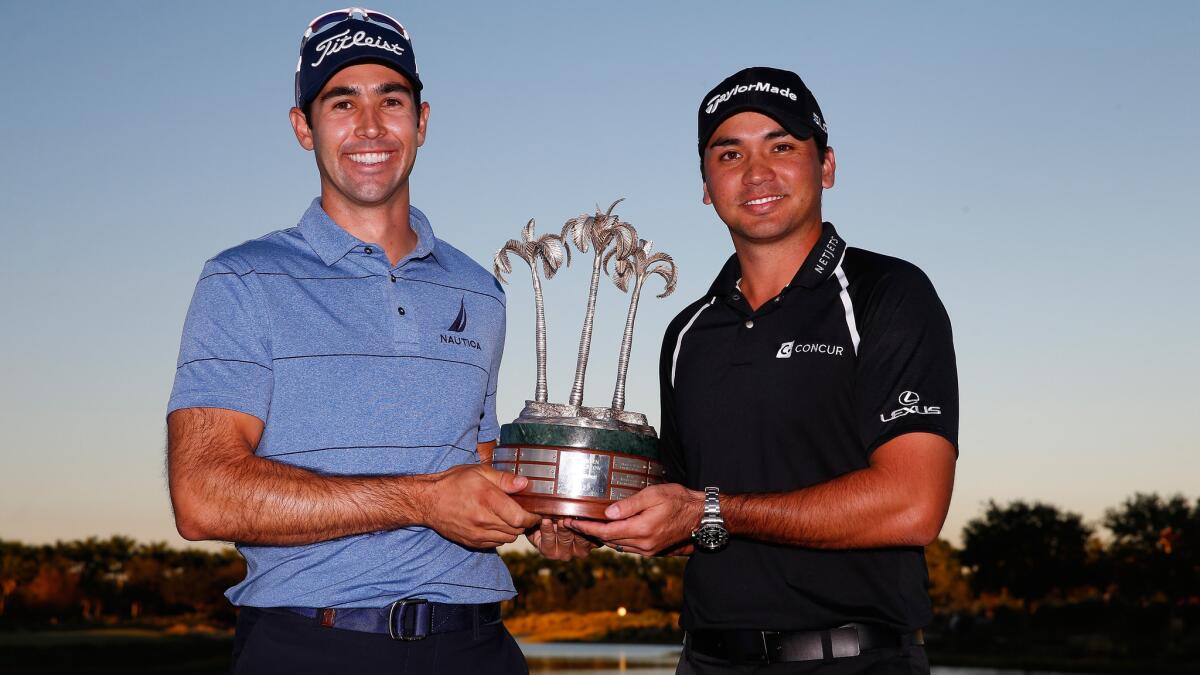 Cameron Tringale, left, and Jason Day pose with their trophy after winning the Franklin Templeton Shootout in Naples, Fla., on Saturday.