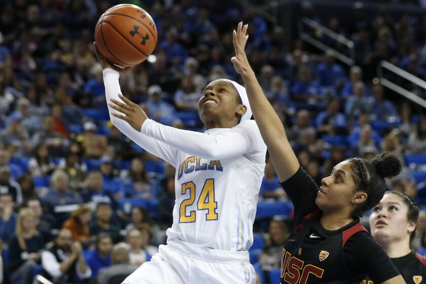LOS ANGELES, CALIF. -- SUNDAY, DECEMBER 29, 2019: ]UCLA Bruins guard Japreece Dean (24) scores a basket guarded by USC Trojans guard Desiree Caldwell (24) in the second half at Pauley Pavilion in Los Angeles, Calif., on Dec. 29, 2019. UCLA won 83-59. (Gary Coronado / Los Angeles Times)