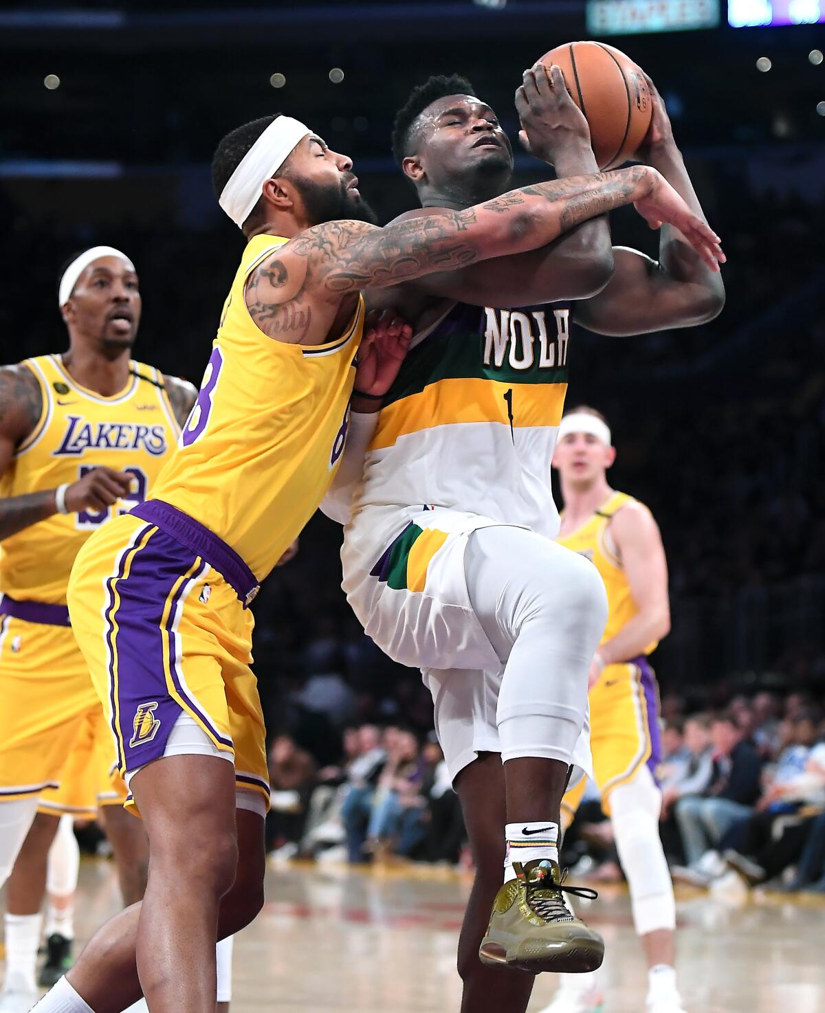 New Orleans Pelicans' Zion Williamson is fouled by Lakers' Markieff Morris while driving to the basket in the fourth quarter at Staples Center on Tuesday. 