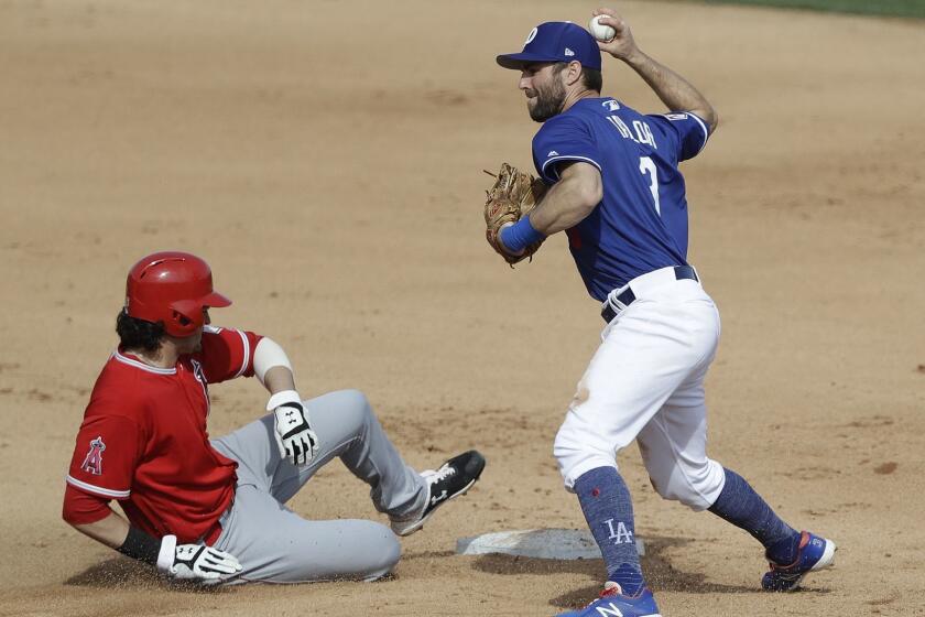 Los Angeles Angels' Jarrett Parker, left, is forced out at second as Los Angeles Dodgers left fielder Chris Taylor fakes a throw to first during the fourth inning of a spring training baseball game, Sunday, Feb. 24, 2019, in Glendale, Ariz. (AP Photo/Darron Cummings)