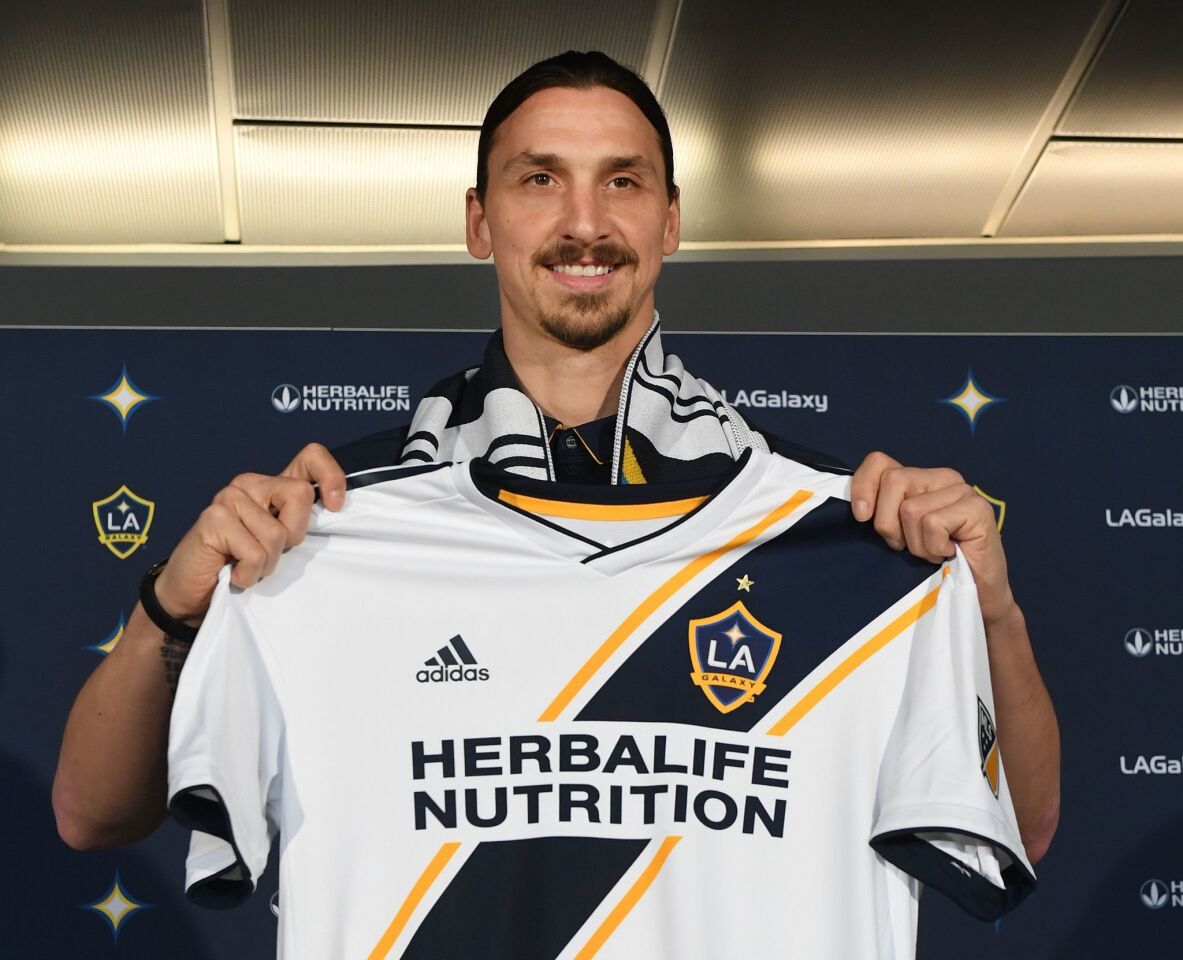 Footballer Zlatan Ibrahimovic holds up a new team jersey, for his new club LA Galaxy, during a first press conference in Los Angeles, California, on March 30, 2018. The 36-year-old Swedish striker's move to MLS from Manchester United was confirmed last week, with Ibrahimovic swiftly vowing to reignite the Galaxy's fortunes after they finished bottom of the league last season. / AFP PHOTO / Mark RALSTONMARK RALSTON/AFP/Getty Images ** OUTS - ELSENT, FPG, CM - OUTS * NM, PH, VA if sourced by CT, LA or MoD **