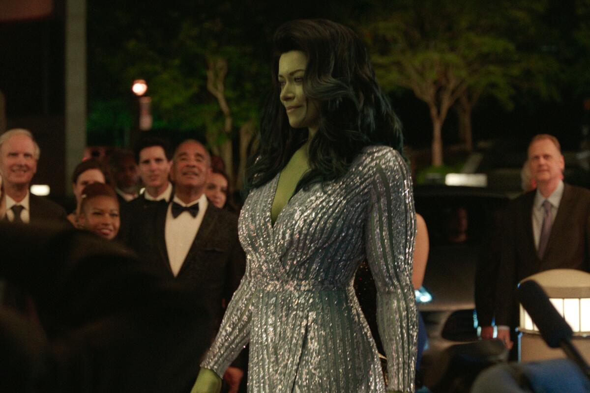 a giant green woman in a fancy dress