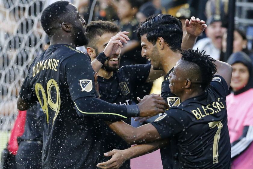 Los Angeles FC forward Carlos Vela, second from right, of Mexico, celebrates his goal with teammates in the second half of an MLS soccer match against Portland Timbers in Los Angeles, Sunday, March 10, 2019. The Los Angeles FC won 4-1. (AP Photo/Ringo H.W. Chiu)