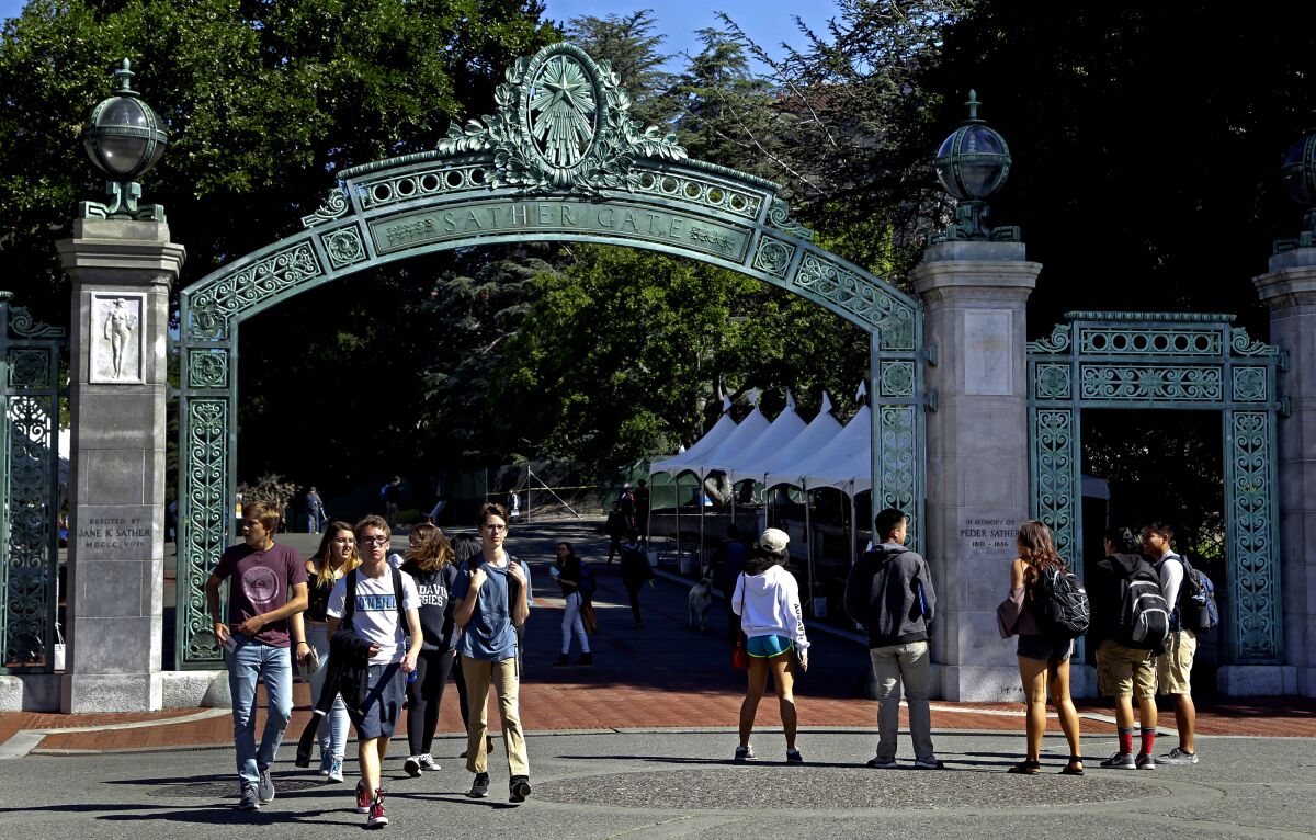 Students walk past Sather Gate at UC Berkeley.