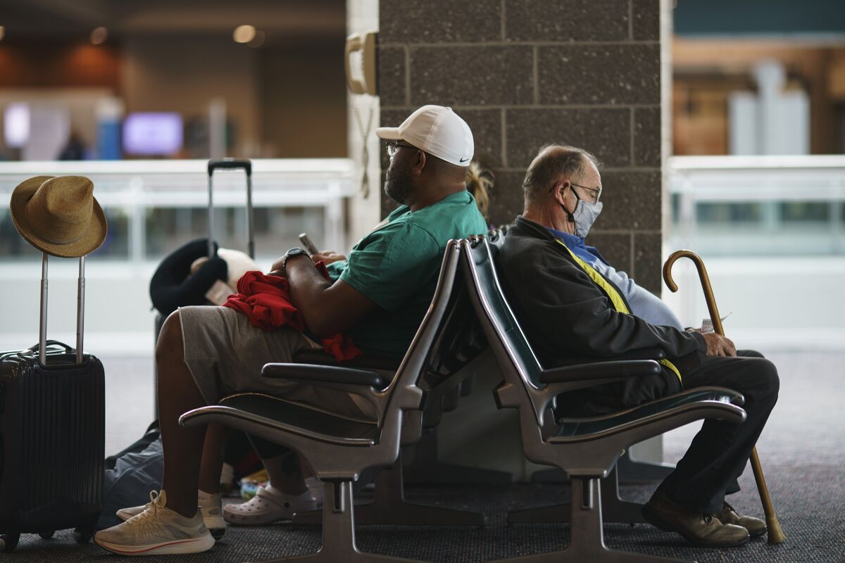 Travelers sit in a waiting area at Rhode Island T.F. Green International Airport
