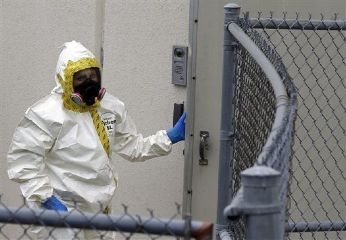 A firefighter in a protective suit walks into a government mail-screening facility in Hyattsville, Md.