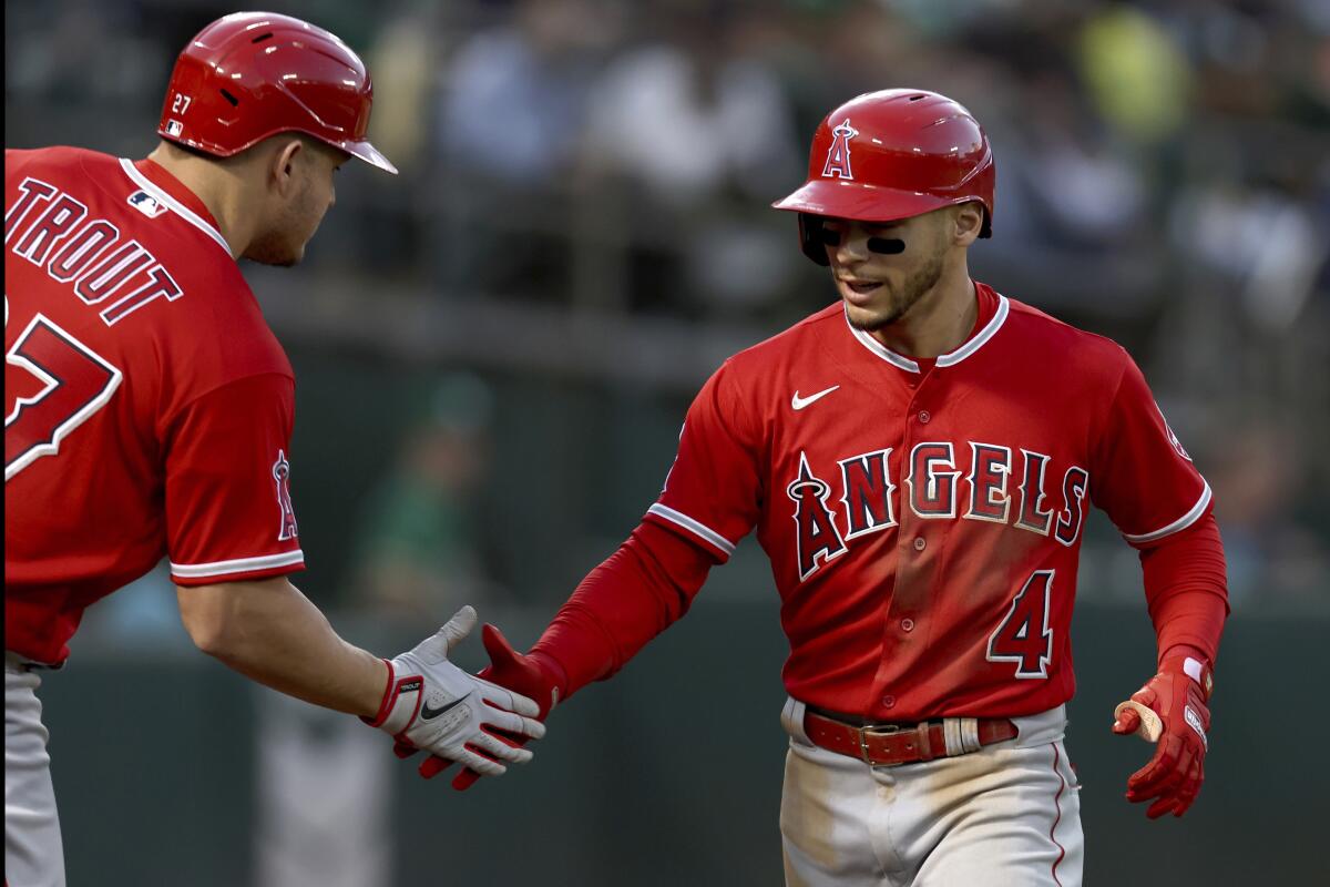 The Angels' Andrew Velazquez, right, is congratulated by Mike Trout after hitting a fifth-inning home run May 13, 2022.