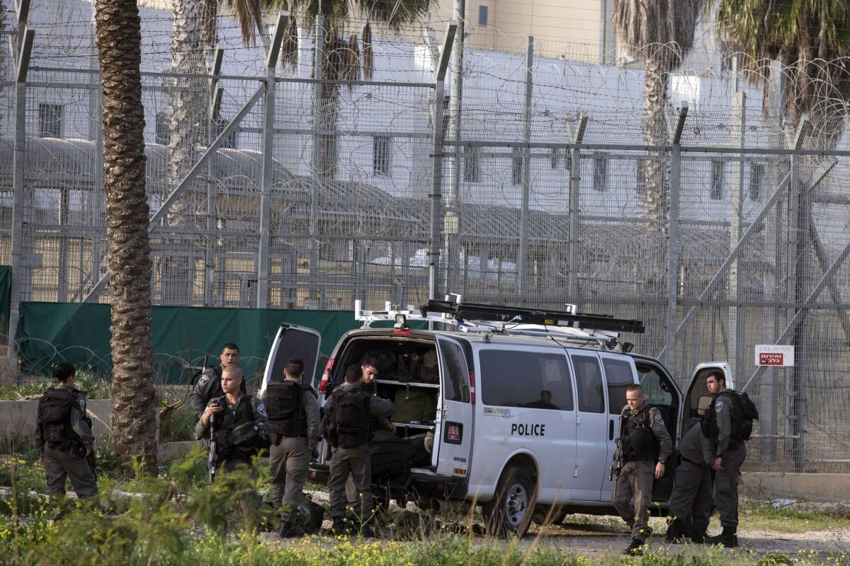 Israeli guards take position Sunday at the entrance to Rimonim high security prison near Tel Aviv after U.S.-born prisoner Samuel Sheinbein reportedly opened fire on guards and was later slain by a SWAT team.