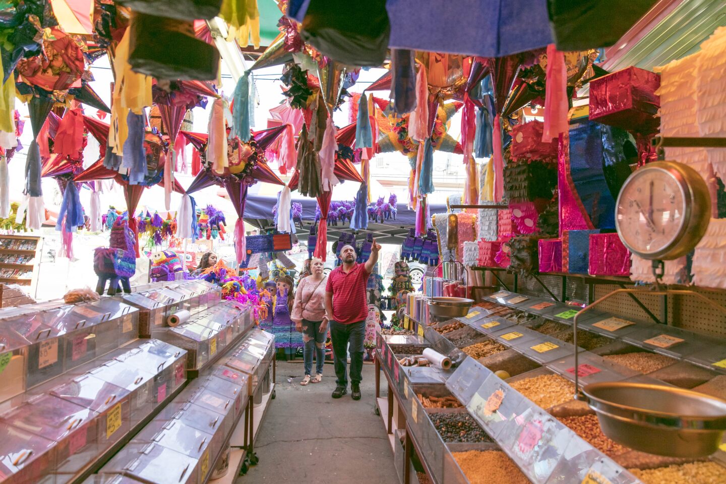 People shop at Tapia's Productos Mexicanos en General, the first and oldest store in the Piñata District.