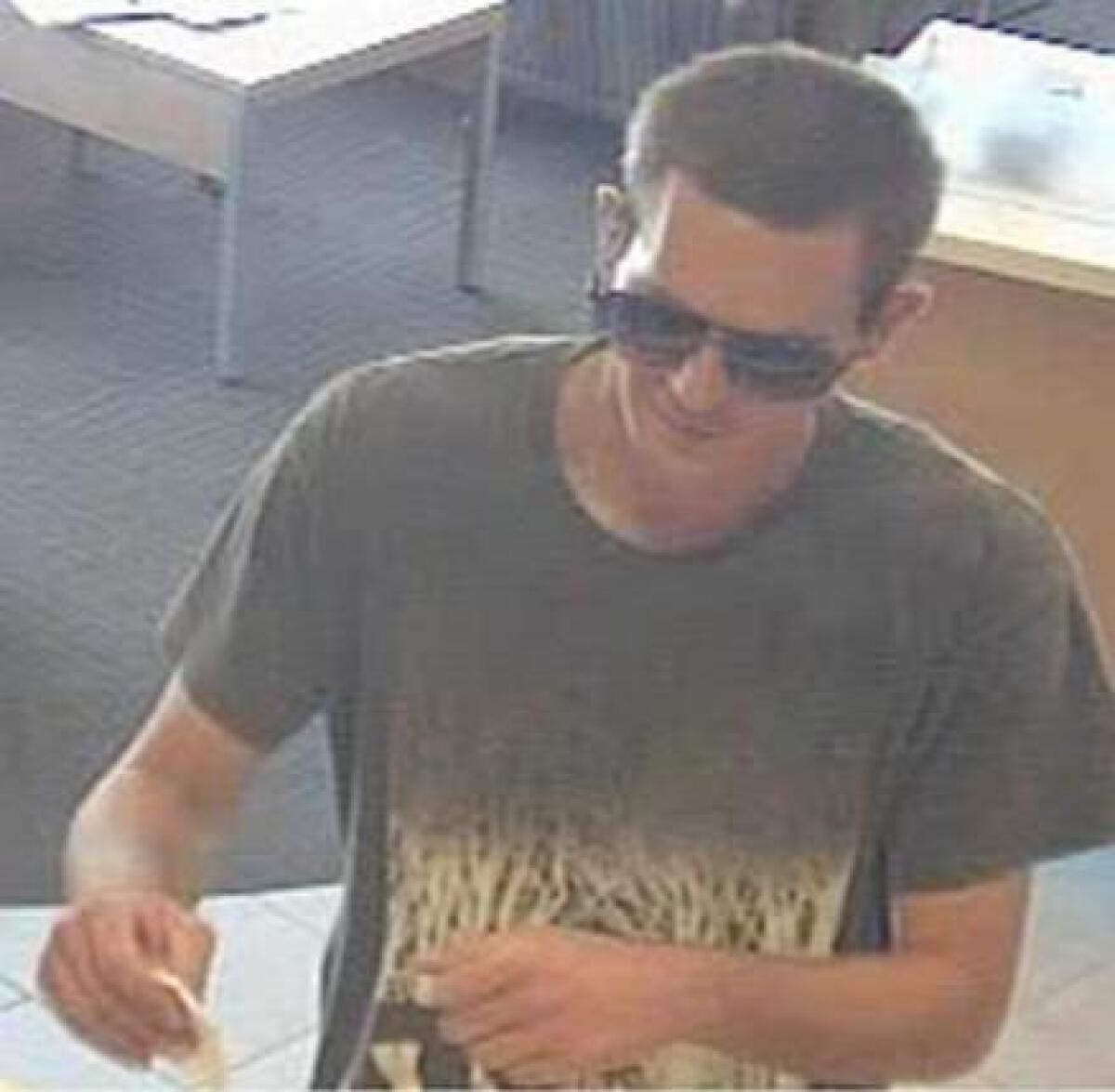 Police released this photo in July of a man in his mid-20s wearing Prada sunglasses who is suspected of robbing a Wells Fargo bank branch in the 3600 block of East Coast Highway.