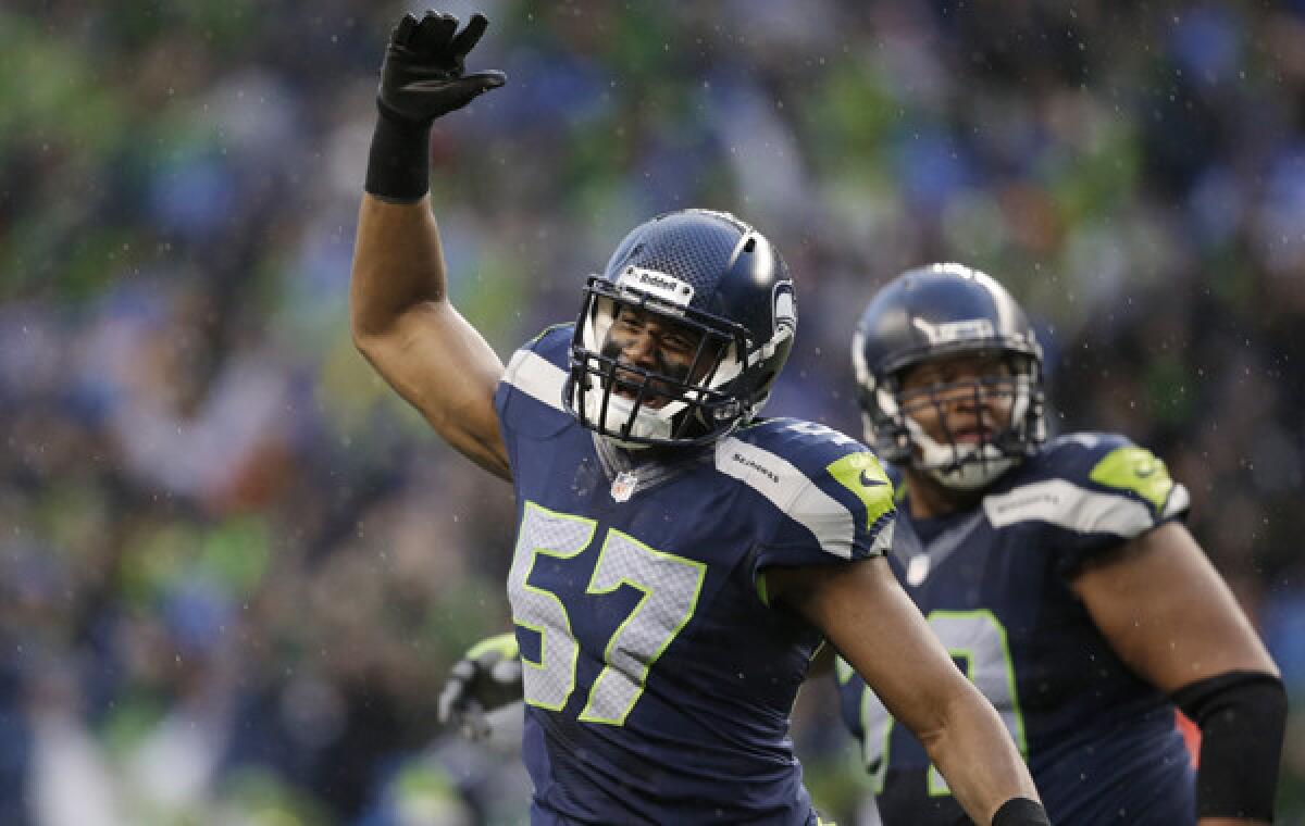 Seattle Seahawks linebacker Mike Morgan celebrates an unsuccessful field-goal attempt by the New Orleans Saints in the NFC divisional playoffs. Morgan, an ex-Trojan, is one of several players competing in the Super Bowl with USC and UCLA connections.