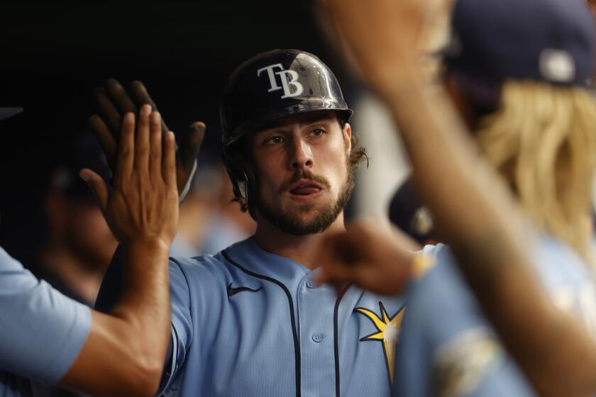 Tampa Bay Rays' Josh Lowe celebrates in the dugout after scoring against the Toronto Blue Jays during the fourth inning of a baseball game Sunday, Sept. 24, 2023, in St. Petersburg, Fla. (AP Photo/Scott Audette)