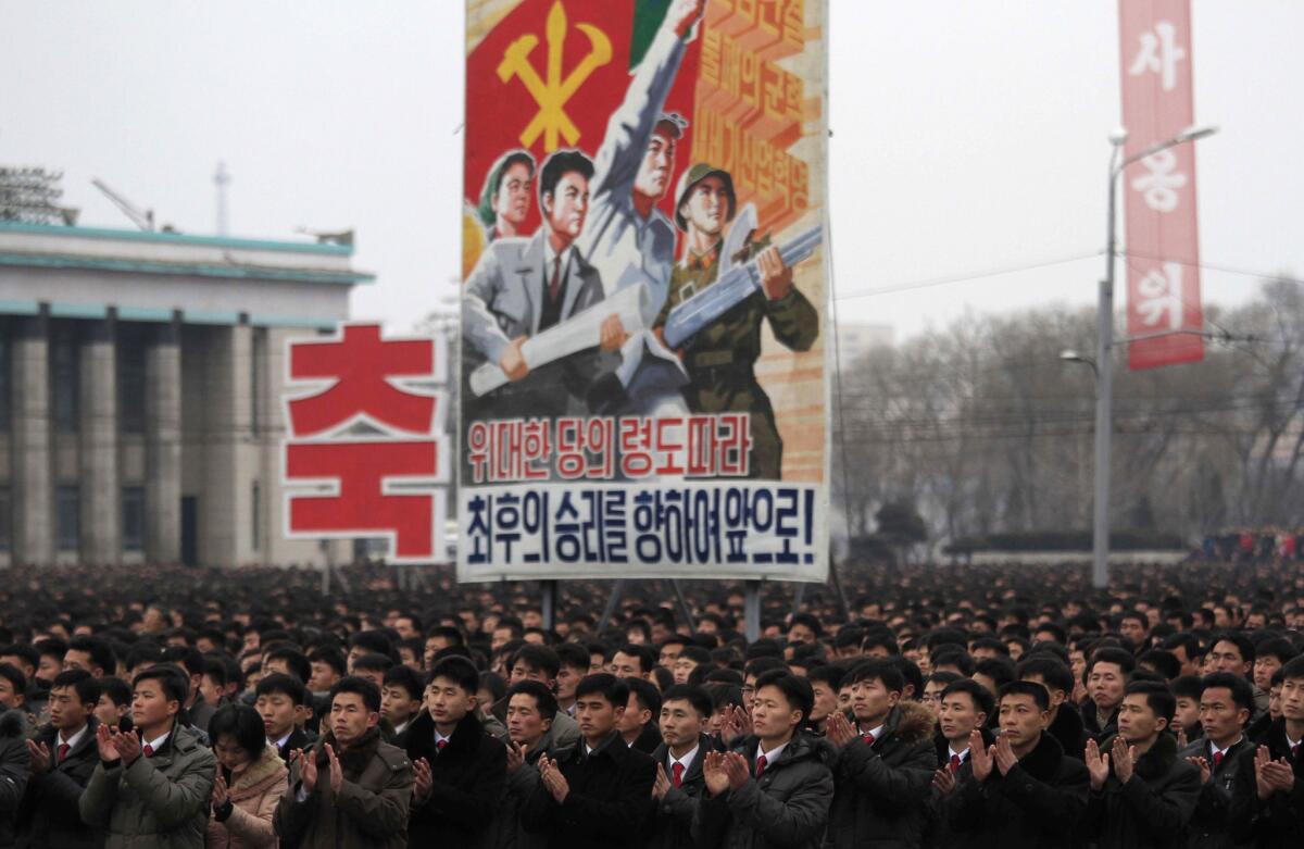 North Koreans gather at the Kim Il Sung Square in Pyongyang to celebrate a satellite launch on Monday