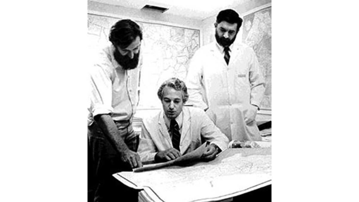 Poring over a county map, from left to right, Dr. Malcolm Pike, Dr. Brian Henderson and Dr. Thomas Mack are considered among the founders of the L.A. County Cancer Surveillance Program.