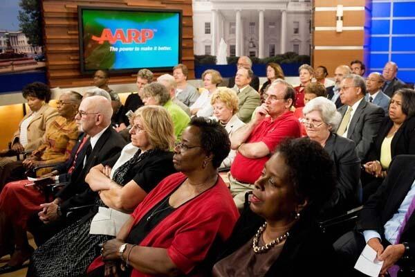 Guests listen to President Obama at an AARP town hall meeting