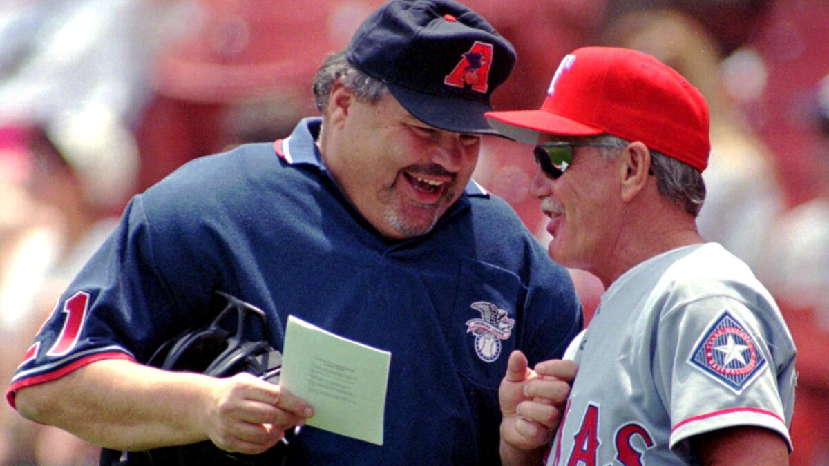 Ken Kaiser and Rangers manager Johnny Oates chat before a game on June 8, 1997.