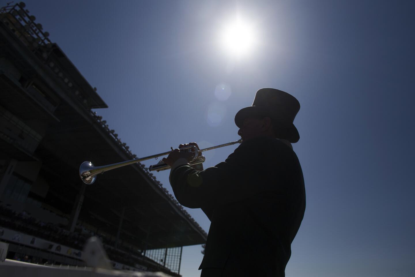 Bugle player John Cohen makes the call to post during Los Alamitos Race Course's opening day of thoroughbred racing on Thursday. Cohen has made the call more than 88,000 times.