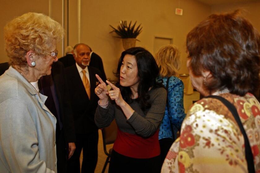 Michelle Rhee, center, answers questions after delivering a speech to the World Affairs Council in Los Angeles.