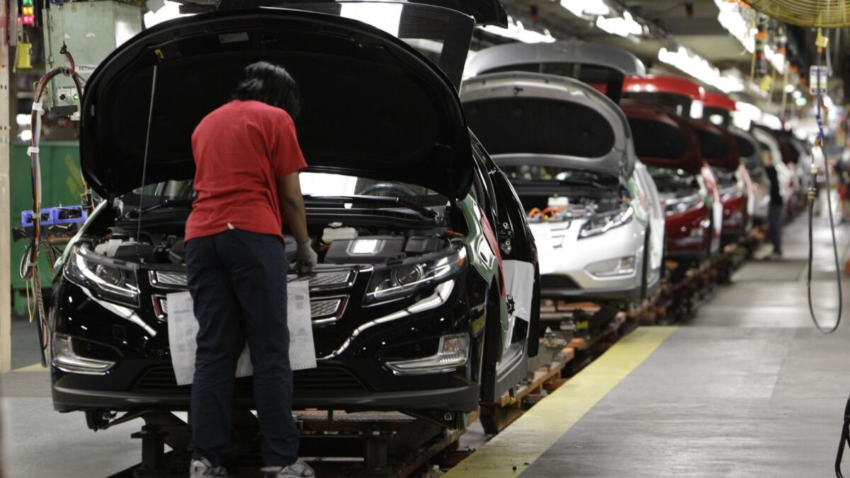 An assembly worker works on a Chevrolet Volt at a General Motors plant in Michigan in 2011.