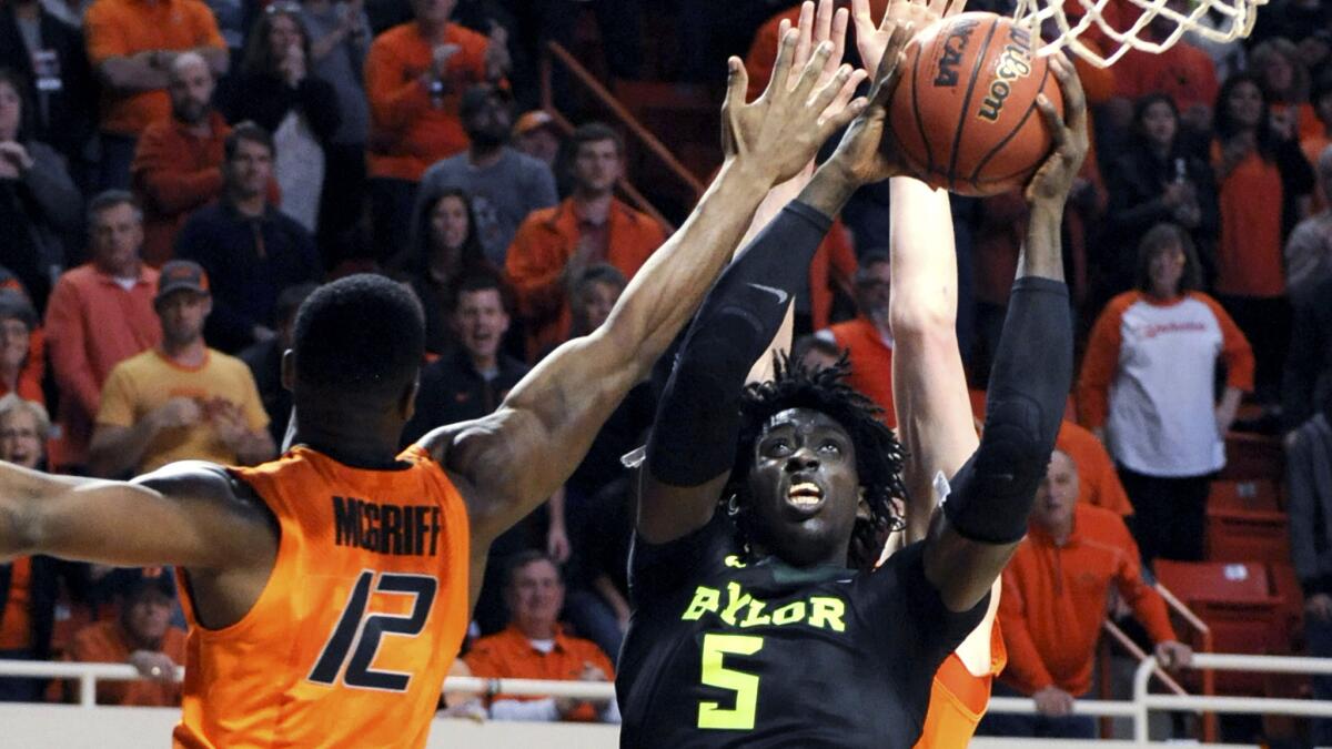 Baylor forward Johnathan Motley takes a shot over Oklahoma State forward Cameron McGriff (12) during the second half Wednesday night.