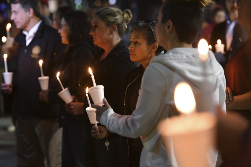 People attend a candlelight vigil for victims of an April 3 downtown Sacramento gunfight.