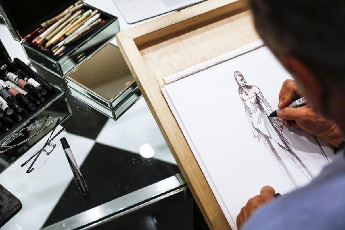 Couturier Mark Zunino sketches a design in his Beverly Hills showroom in March.