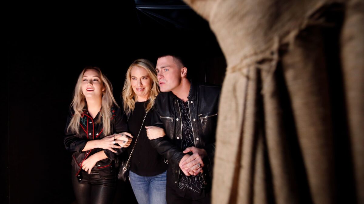 Cast members of FX's "American Horror Story: Roanoke," from left, Billie Lourd, Leslie Grossman and Colton Haynes get spooked in the Universal Studios maze based on their TV show.