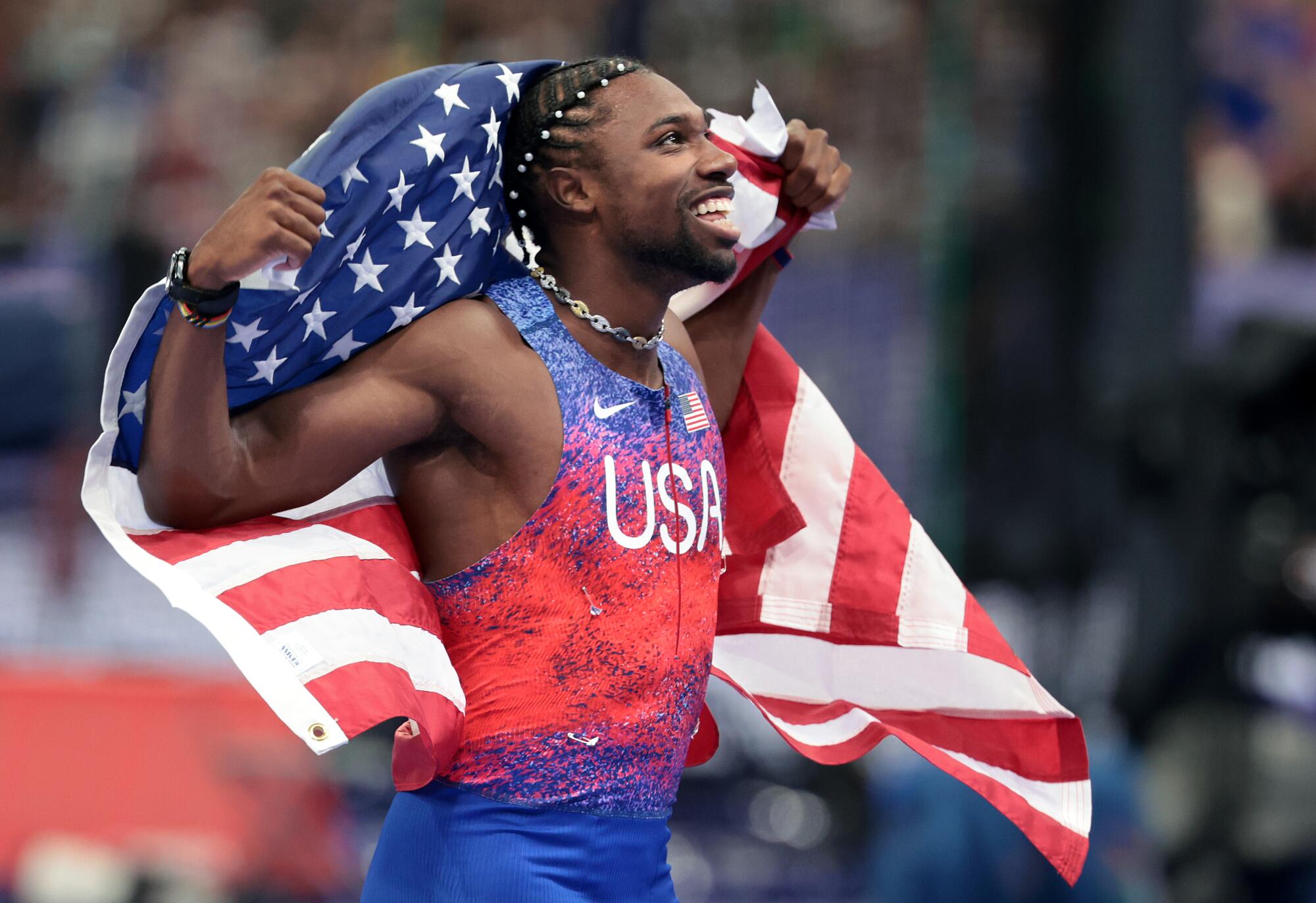 Noah Lyles celebrates after winning gold in the men's 100 meters Sunday at the Paris Olympics.