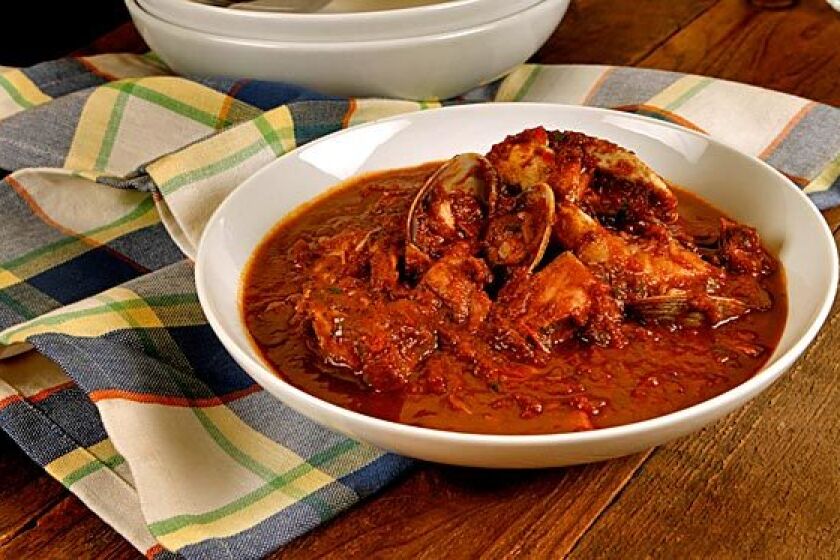 Cioppino basics are wine, tomatoes and assorted seafood.