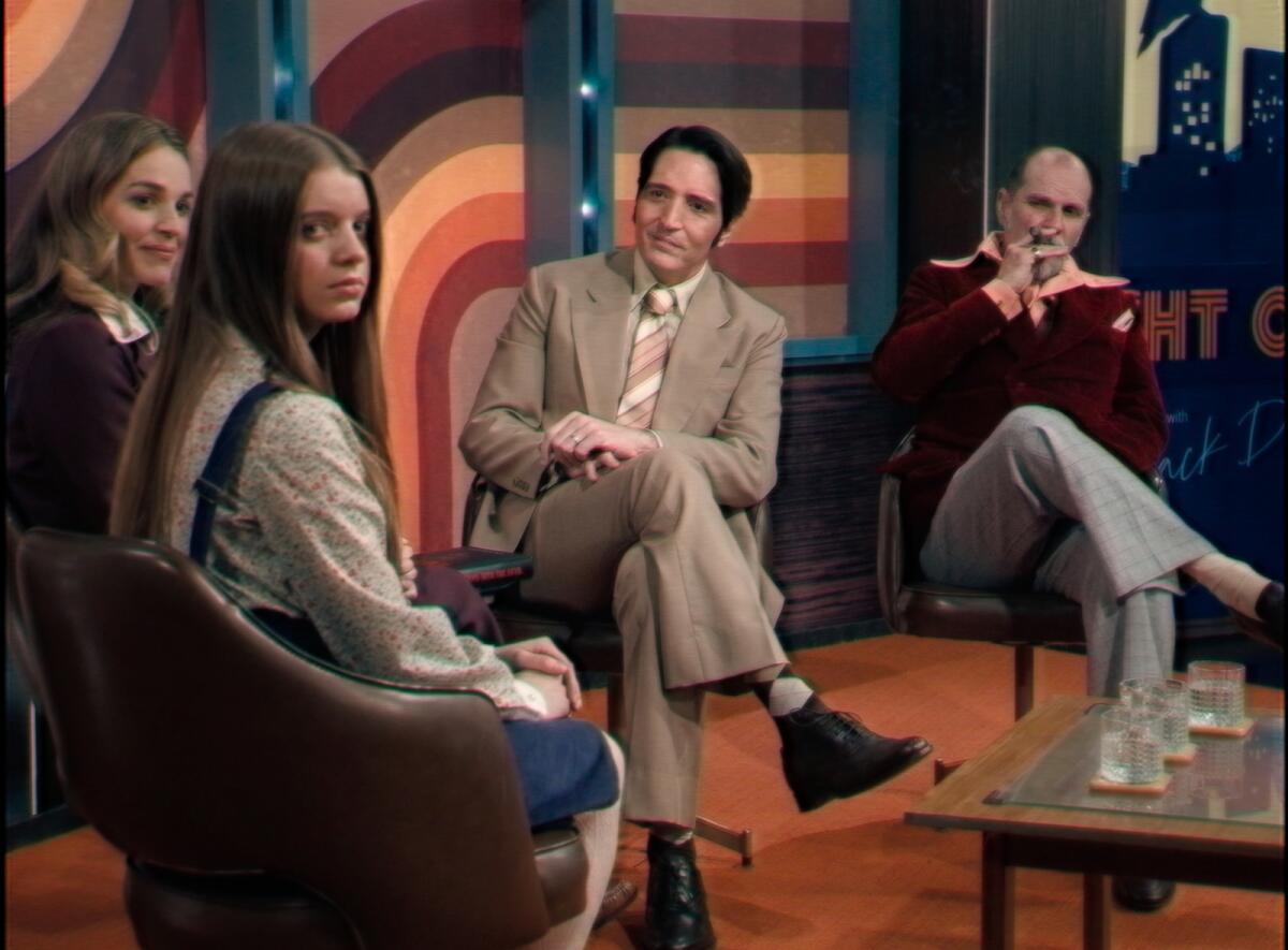 Two women and two men seated on a 1970s TV talk show set