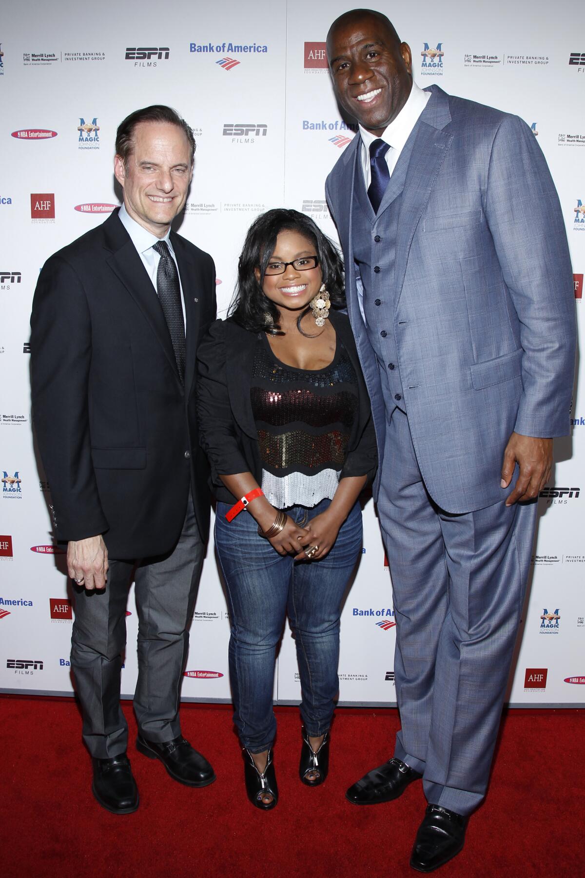 Michael Weinstein, left, Hydeia Broadbent and Magic Johnson attend the premiere of 'The Announcement'