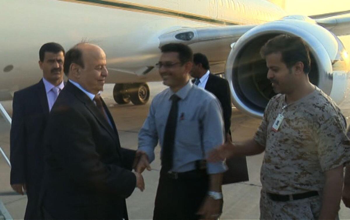Video released by the office of President Abdu Rabu Mansour Hadi showed Yemen's leader, second from left, arriving at an air base in the southern port city of Aden on Sept. 22, 2015.