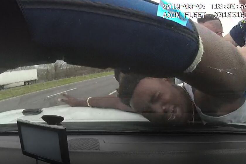 FILE - In this March 2, 2019 image from police dashboard camera video, Louisiana State Trooper Jacob Brown slams motorist DeShawn Washington against the hood of a police cruiser during a traffic stop in Ouachita Parish, La., after troopers found marijuana in the trunk of Washington's car. (Louisiana State Police via AP, File)