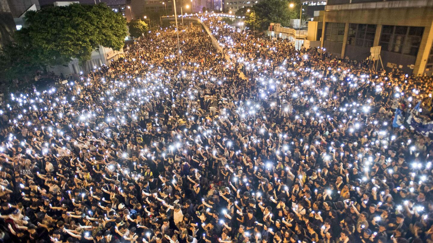 Pro-democracy demonstrators hold up their mobile phones during a protest near the Hong Kong government headquarters on Sept. 29.