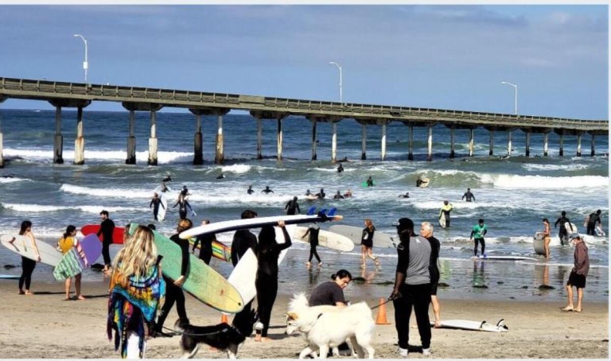 Surfers hit the waves in Ocean Beach on June 7 during a paddle-out in support of the Black Lives Matter movement.